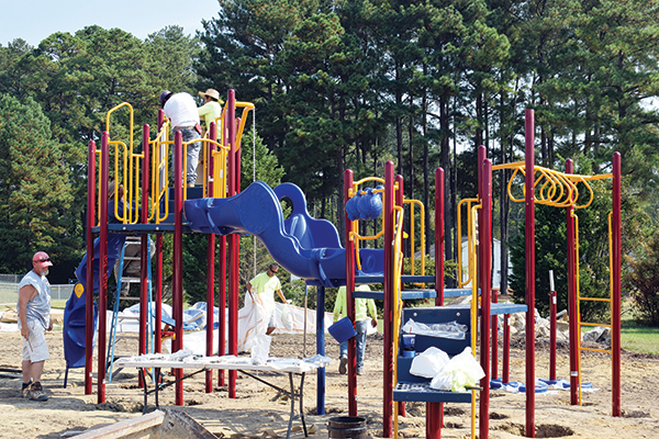 Youth enjoy new playground equipment at Glover Park
